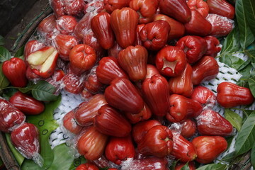 The rose apple is a red fruit from Vietnam that is shaped like a bell and has a flavour similar to unripe pears. It is also known as Quả Roi in the north and Quả Mận in the south.