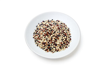 Organic Tri-color Quinoa (Mixed Quinoa) placed on a white plate isolated on white background. Quinoa is a round seed that is high in protein, high in energy, and rich in high fiber.