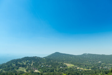 Obraz premium Small houses separated from each other on a mountain range., surrounded by trees. View of landmark of Khao Yai Thieng Windmill Nakhon Ratchasima Thailand.