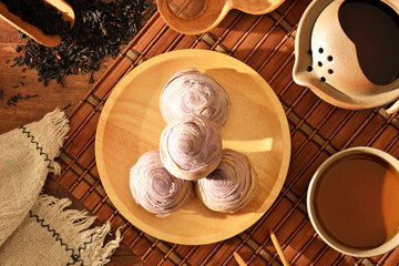 Taro cake on wooden plate and tea set   