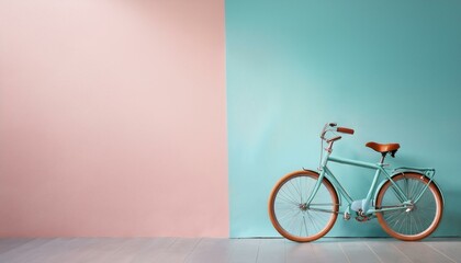 Fototapeta premium A classic bicycle leaning against a pastel-painted wall, with most of the space left intenti