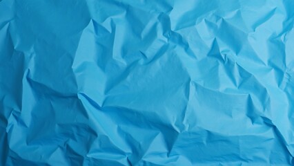 Abstract Crumpled Blue Paper Texture Background, Vibrant Blue Wrapping Paper with Deep Creases and Folds, Perfect for Design Projects