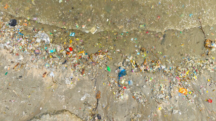 trash, plastic cups and plastic bags at the beach. environmental problem concept and healing the...