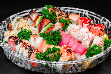 Deluxe Sushi Platter with Assorted Rolls and Sashimi on a Black Background