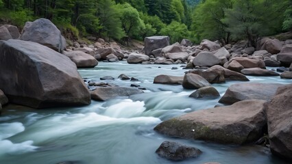 Serene River Flowing Through Large Rocks, Lush Green Foliage - Stunning Nature Photography