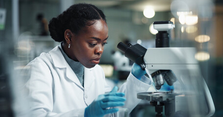 Black woman, scientist and microscope for lab research and medical study with pharma investigation....