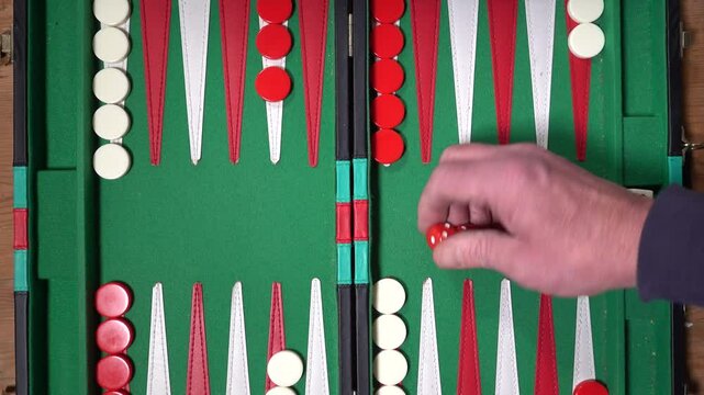 Stockholm, Sweden A hand throws the dice over a backgammon board. 