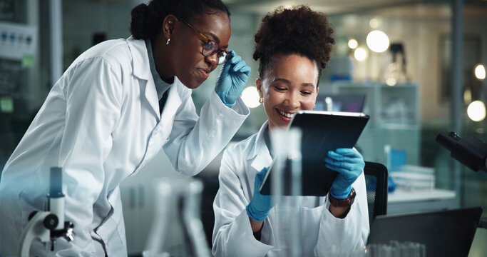 Science, women and happy with tablet for news, advice and research breakthrough at night. Scientist team, tech or smile in dark lab for deadline, pharmaceutical development or study feedback with app
