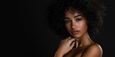 Fototapeta premium Studio shot of a model posing with dramatic lighting and a black backdrop