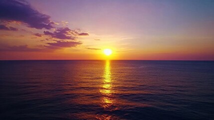 Obraz premium Serene sunset over calm ocean waters, reflecting vibrant colors.