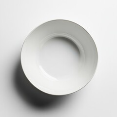 A single white bowl sits on a white surface