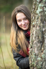 Portrait of a young beautiful long-haired girl in nature.