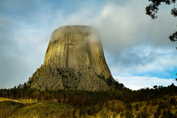 Devils Tower National Monument under partly sunny sky
