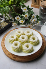 Kuih Puteri Ayu, a popular traditional Malaysian steamed sponge pandan coconut cake.