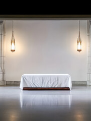 Elegant display space with a draped table under soft lighting in a minimalist setting