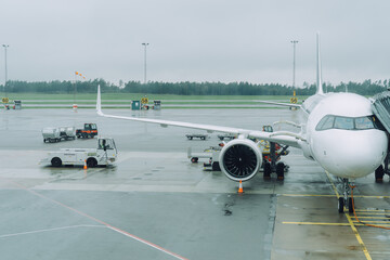 Rainy Day Airport with Ground Handling and Passenger Plane