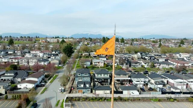 Nishan Sahib - Sikh Flag Of Khalsa Diwan Society Vancouver In British Columbia, Canada. - aerial closeup shot