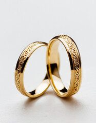 Pair of gold Wedding ring on a white background, macro shot
