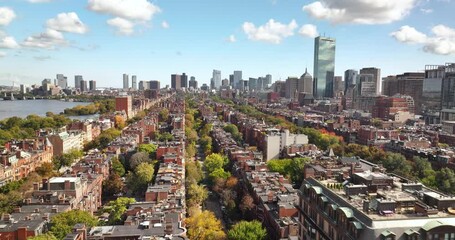 Aerial over brick brownstones and autumn trees with the Boston city skyline - Powered by Adobe