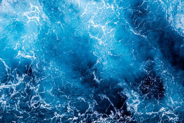 Sea water surface texture. Aerial view of elegant water with foam. Can be used in covers, packaging, posters, textures, cards, art and design projects. Awesome nature background image.