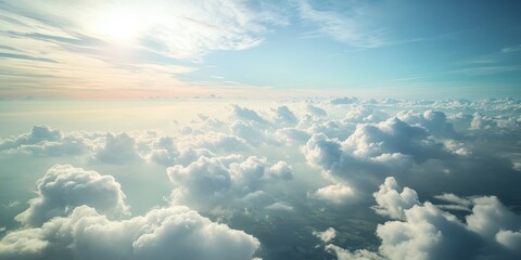 Aerial view of land and clouds captured from an airplane, showcasing the stunning interplay of terrain and cloud formations visible during the flight from the airplane perspective.