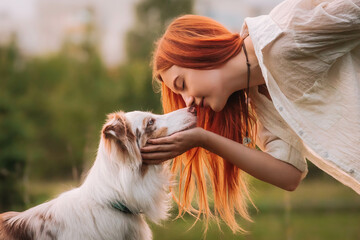 girl with red hair and Australian Shepherd dog face to face. love and friendship between man and dog