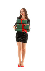 Young woman with gifts on white background. New Year celebration