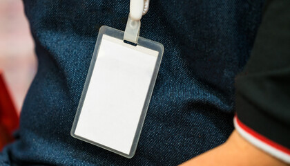 Worker wearing an identification white blank plastic id card.
