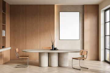 Minimalist dining room with blank framed poster on wooden wall, modern furniture, and natural lighting. 3D Rendering