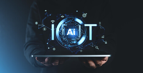 Holographic IoT and AI display concept over tablet on dark background.