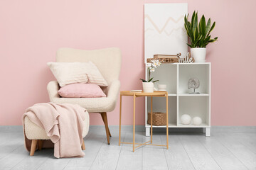 White armchair with soft cushions in stylish living room