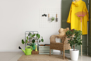 Interior of room with gardening tools, pin board and armchair
