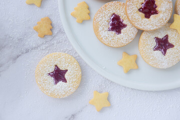 Christmas linzer cookies, shortbread cookies with homemade mix berry jam..