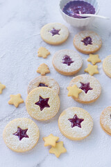 Christmas linzer cookies, shortbread cookies with homemade mix berry jam..