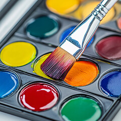 close up of watercolor paint palette and paintbrush for art projects and crafting