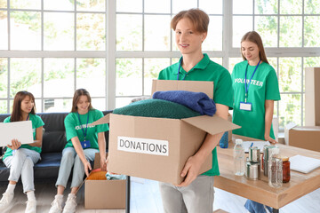 Young male volunteer with donations for poor people in center