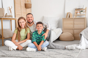 Cute little children with their father in bedroom