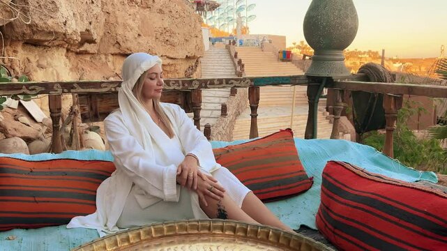 A beautiful girl in traditional clothes rests in a cafe in Egypt