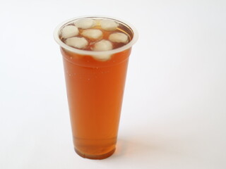 A refreshing iced tea served in a convenient plastic cup. A classic iced tea, served in a disposable clear plastic cup. Indonesia classic beverage