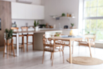 Modern interior of kitchen with dining table. Blurred view