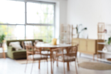 Stylish dining table in living room. Blurred view