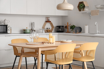 Candles on tray on table in interior of modern kitchen