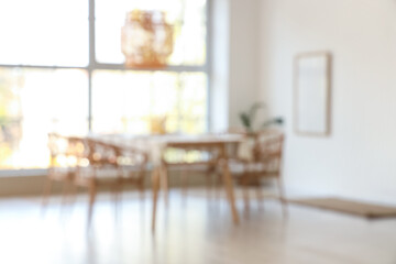 Beautiful table setting with candles in dining room. Blurred view