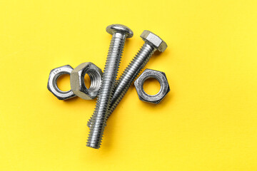 Tap bolts with chrome nuts on yellow background