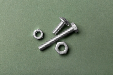 Tap bolts with chrome nuts on green background