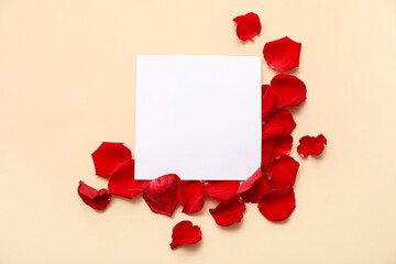 Blank card with beautiful red rose petals on beige background