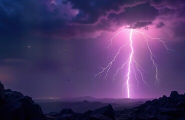 Dramatic night sky with powerful lightning storm. Birds fly in dark sky. Stormy clouds above dark landscape. Rocks silhouettes stand at edge. Nighttime. City lights visible in valley below. Nature