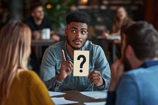 African American Man Holding Question Card in Group Quiz Activity at Cozy Cafe.