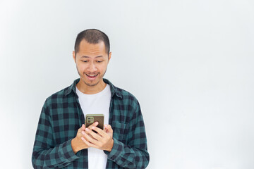 Young Asian men with flannel and shirt is holding his smartphone with isolated white background