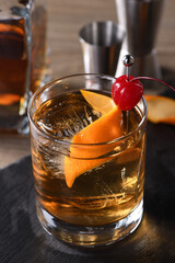 Cocktail Old Fashioned is an old-fashioned sophistication of whiskey and sweet syrup. Served with ice, orange zest and Maraschino cherry. 